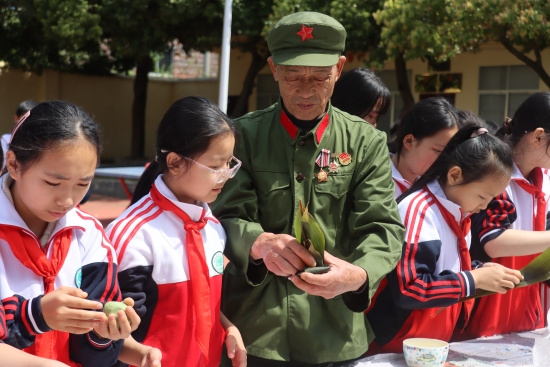 老兵与学生在红星学园一起包青团。受访单位供图
