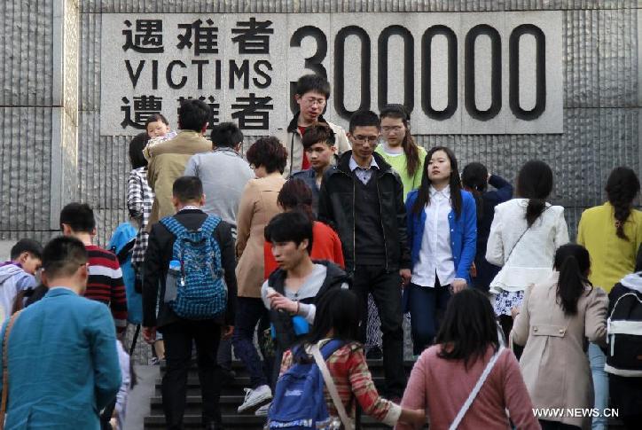 People mourn the Nanjing Massacre victims at the Memorial Hall of the Victims in Nanjing Massacre by Japanese Invaders in Nanjing, capital of east China's Jiangsu Province, April 5, 2014, on the occasion of the Qingming Festival, or the Tomb-Sweeping Day.