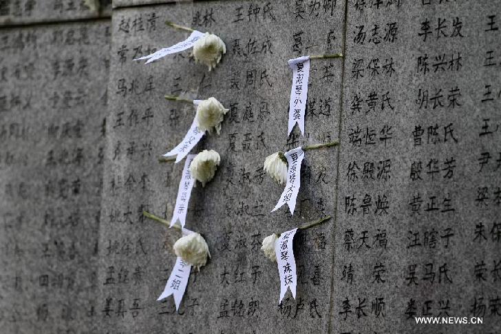 Flowers are presented to mourn the Nanjing Massacre victims at the Memorial Hall of the Victims in Nanjing Massacre by Japanese Invaders in Nanjing, capital of east China's Jiangsu Province, April 5, 2014, on the occasion of the Qingming Festival, or the Tomb-Sweeping Day.