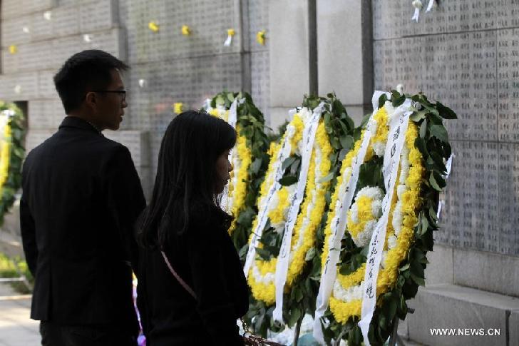 People mourn the Nanjing Massacre victims at the Memorial Hall of the Victims in Nanjing Massacre by Japanese Invaders in Nanjing, capital of east China's Jiangsu Province, April 5, 2014, on the occasion of the Qingming Festival, or the Tomb-Sweeping Day. 