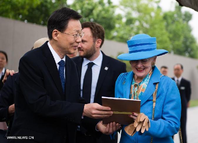 Queen of Denmark Margrethe II (R) receives a picture album from Li Xueyong, governor of east China's Jiangsu province, while visiting the Memorial Hall of the Victims in Nanjing Massacre by Japanese Invaders, in Nanjing, capital of Jiangsu Province, April 27, 2014.