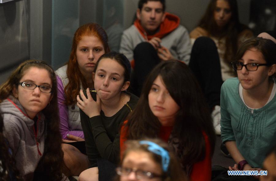 Students listen to a Holocaust survivor in the Museum of Jewish Heritage in New York City, the United States, on April 28, 2014. An event named 'A Living Memorial to the Holocaust' is held here for commemoration of Holocaust Remembrance Day on Monday. Holocaust survivors from Poland, Germany, and Belgium who are now living in New York met with more than 300 students and visitorsg here and shared with them what they had been thourgh during the Holocaust. (Xinhua/Wang Lei) 