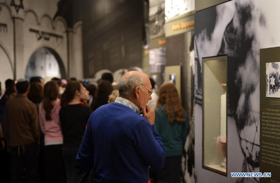 A visitor watches exhibits about hisitory of Holocaust in the Museum of Jewish Heritage in New York City, the United States, on April 28, 2014. An event named 'A Living Memorial to the Holocaust' is held here for commemoration of Holocaust Remembrance Day on Monday. Holocaust survivors from Poland, Germany, and Belgium who are now living in New York met with more than 300 students and visitorsg here and shared with them what they had been thourgh during the Holocaust. (Xinhua/Wang Lei) 